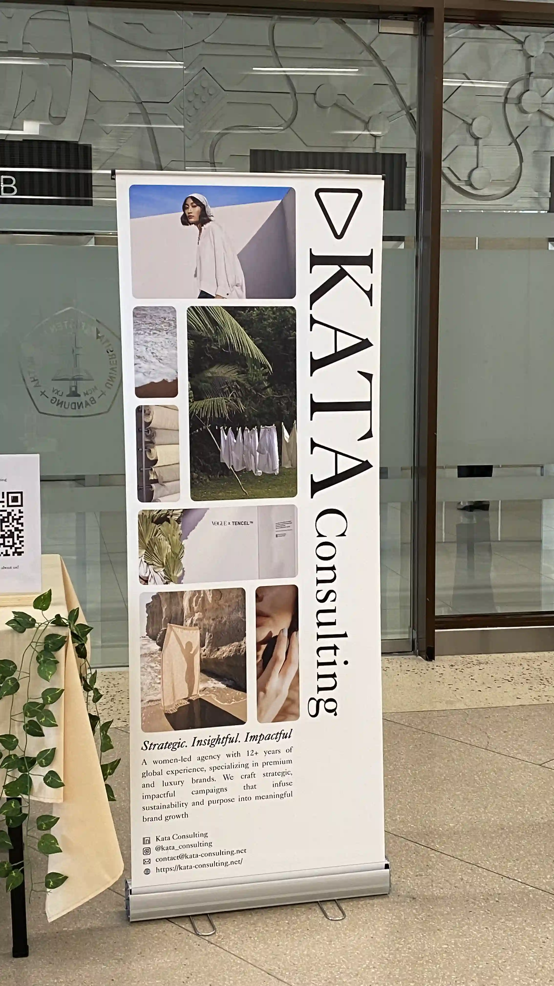 KATA Consulting roll-up banner display at an event, with brand imagery and mission statement